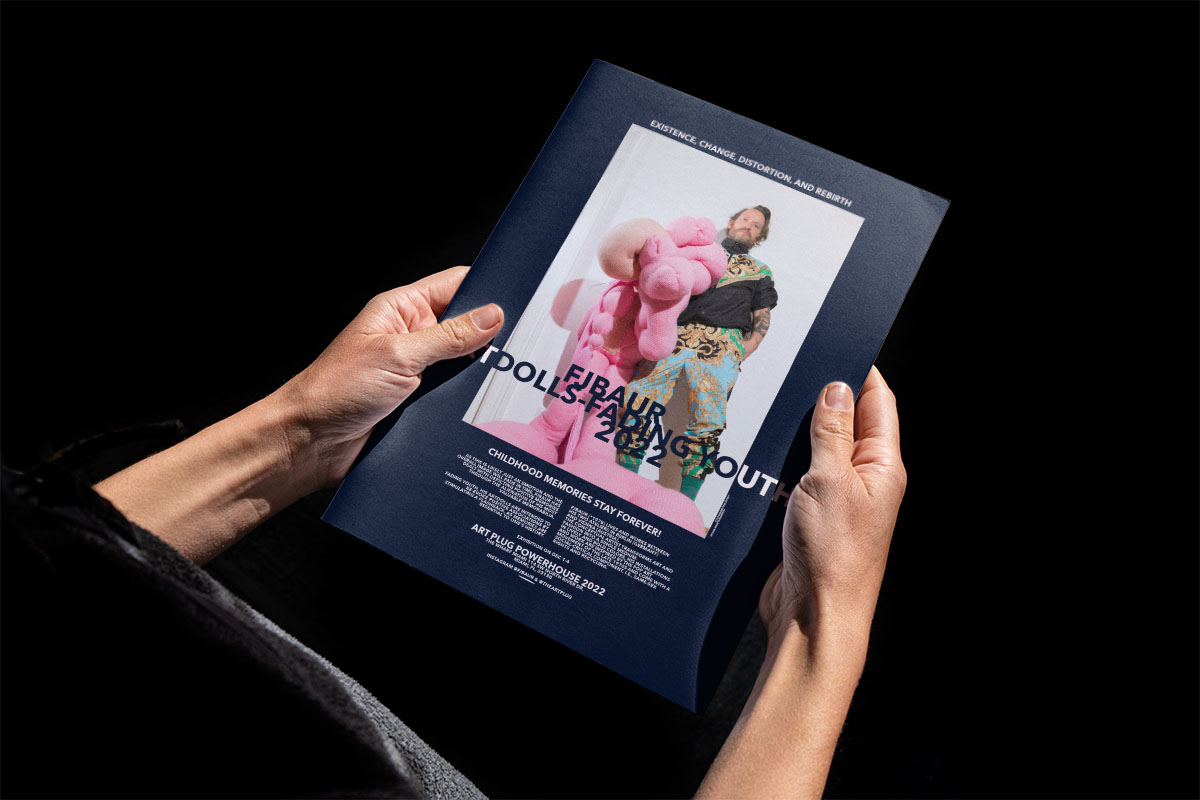 hands holding a magazine showing an elegant full page ad for FJBAURs Art Week Miami eihibition